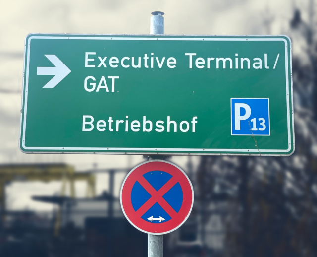 Ein Foto eines Schildes mit der Aufschrift "Executive Terminal / GAT" und einem Richtungspfeil.